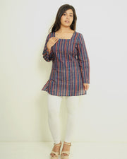 Model wearing Anandira Neelrekha indigo multicolour striped short kurti with square neck and flared sleeves